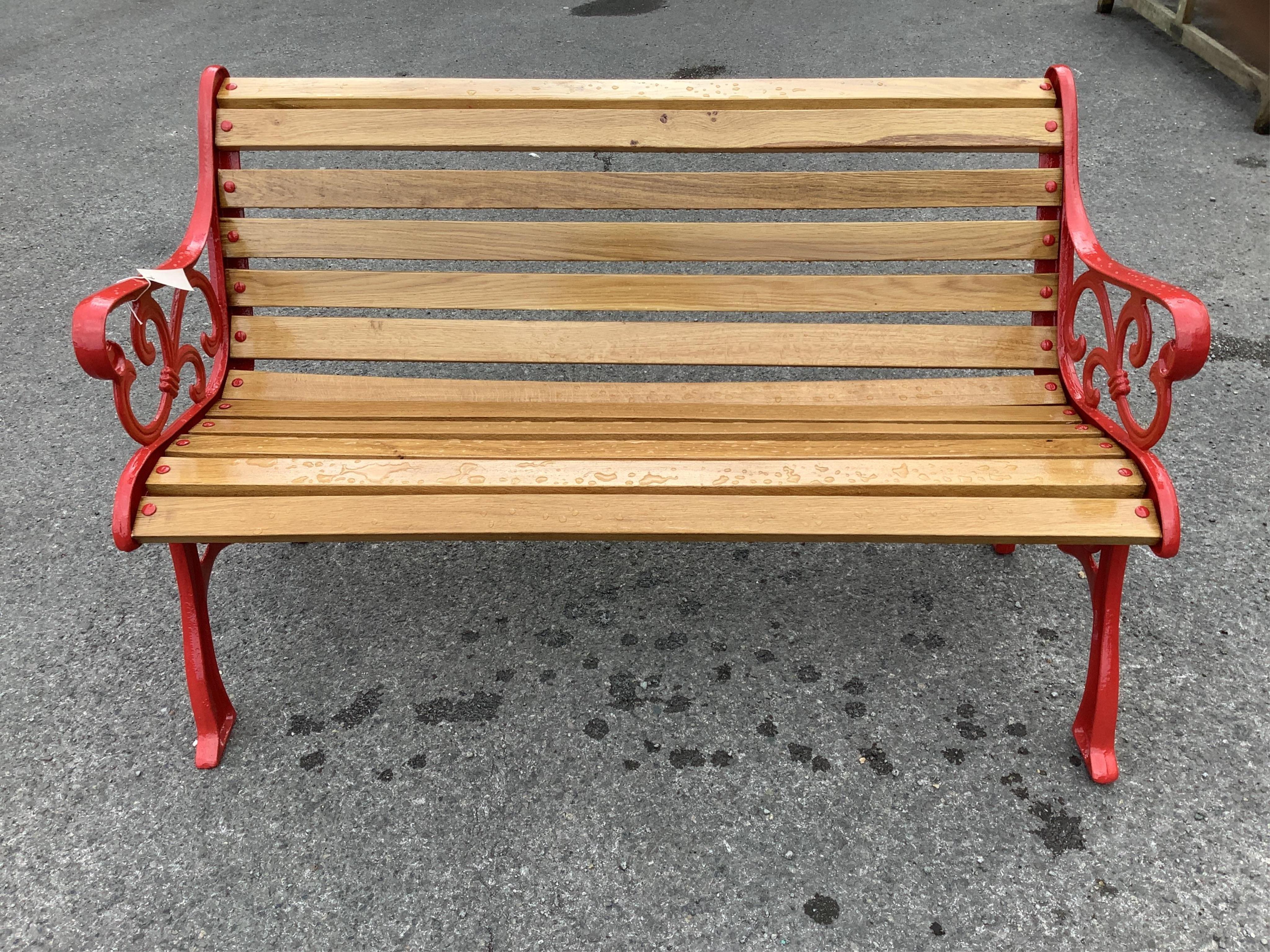 A Victorian style cast metal slatted wood garden bench, width 128cm, height 78cm